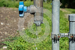 Water valve pipe with running water in garden hot