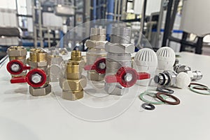 Water valves, fittings and thermostats on the table