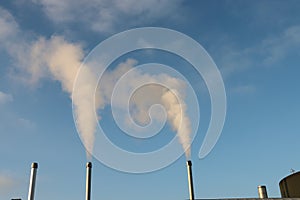 Water vapour comes out of a chimney on a cold day