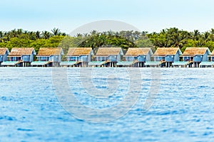 Water villas on tropical caribbean island, Maldives. Copy space for text.