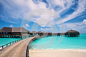 Water villas and wooden jetty of the resort in the Maldives