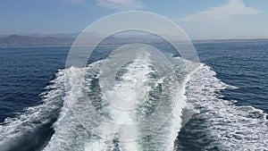 Water wake behind a speeding boat