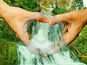 Water waterfall and hands fingers like heart  love background