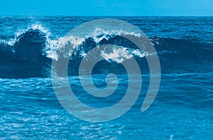 Water wave splash on blue sea background