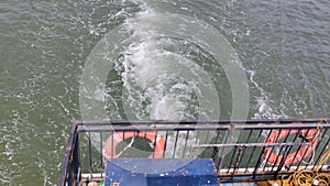 Water waves behind the boat in a sea