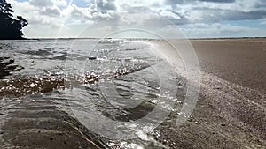 Water waves on sand beach, tourist destination, water care concept