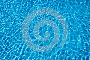 Water waves in summer outdoor pool with reflection on bottom. Surface of water. Background