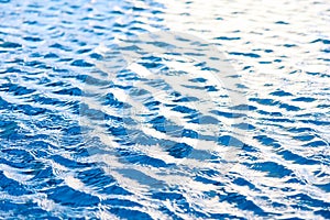 Water waves surface background. Aqua background texture. Abstract water ripples selective focus. Design element for banner