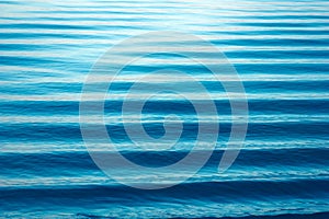 Water waves texture. Beautiful lake minimalist landscape,. Blue waves, horizon lines on water. Place for text
