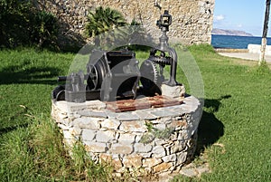 Water well with antique water pump.