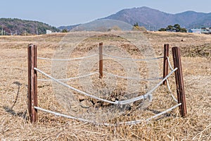 Water well cordoned off with wooden beams and rope