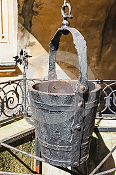 A water well with an old bucket