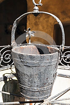 A water well with an old bucket