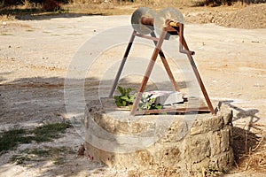 A water well with an old bucket