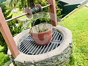 Water Well With Pulley and Bucket in the garden.