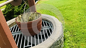 Water Well With Pulley and Bucket in the garden. close up.