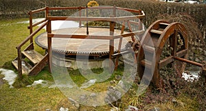Water wheel covered in plants