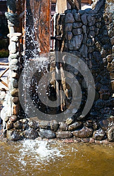 Water wheel and running water on a stone structure