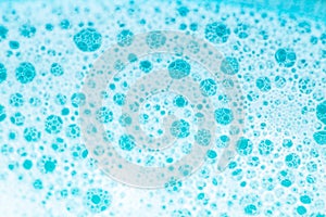 water with white foam bubbles.Cleanliness and hygiene background. Foam Water Soap Suds.Texture Foam. blue soap bubbles