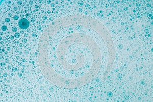 water with white foam bubbles.Cleanliness and hygiene. Foam Water Soap Suds.Texture Foam. blue soap bubbles background