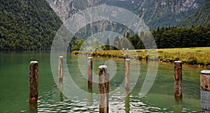 Water and wooden mooring posts at the lake