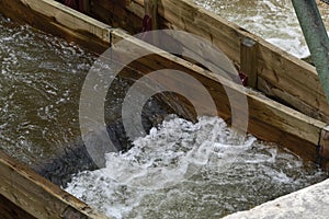 Water in wooden troughs on a dam.