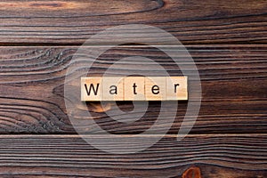water word written on wood block. water text on cement table for your desing, concept