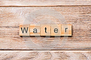 Water word written on wood block. water text on wooden table for your desing, concept