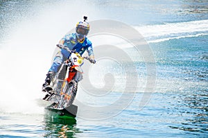 WaterBike ride by Robbie Maddison Australian stunt rider, the image shows how to ride his dirt bike on water in action.