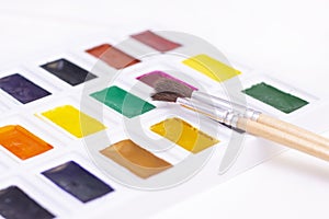 Watercolor art paint with brushes. A palette of multi-colored paints for drawing with water.