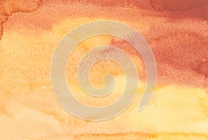 Watercolor bright yellow, peach and reddish-brown background. Stains on paper, liquid backdrop. Blurred texture