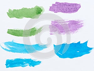 Watercolor brush stroke of blue and green paint, on a white background