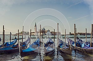 Watercolor effect of gondolas pier row anchored photo on Canal Grande with San Giorgio Maggiore church in the background, Venice,