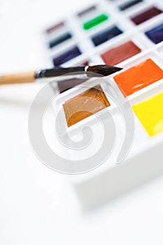 Watercolor paint palette with brush