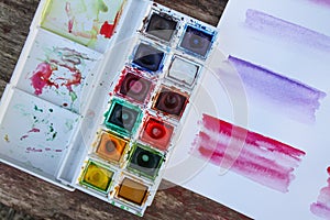Watercolor paints palette and paper