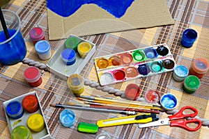 Watercolor paints and paper closeup for drawing, artistic creation at home, workspace for make creative artwork