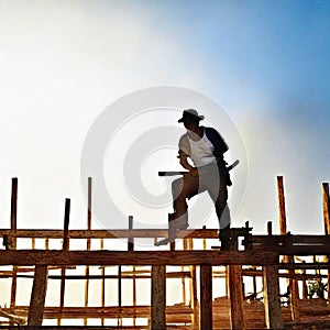 Watercolor of roofer working on roof structure at construction site