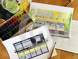 Watercolor sketches of house on table