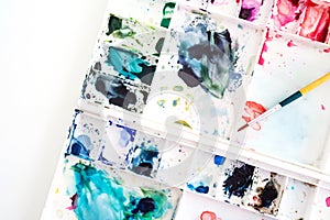 Watercolor tray with paint brush. Art and abstract background. T