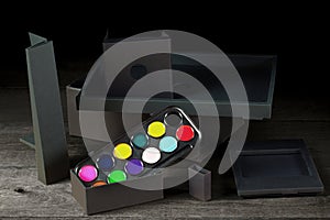 Watercolors and various black ÃÂonstructions on a wooden table