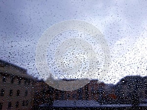 Waterdrops over the window after summer rain in the city