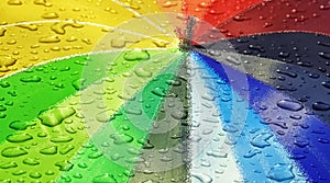 Waterdrops on rainbow coloured parasol