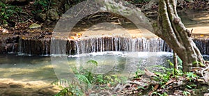 Waterfall along a tropical river in Thailand