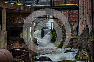 Waterfall through ancient industry buildings