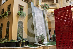 The waterfall atrium surrounded by lush green trees and plants at The Venetian Resort and Hotel in Las Vegas Nevada