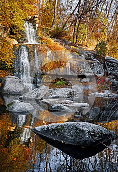 Waterfall in autumn park. Picturesque landscape