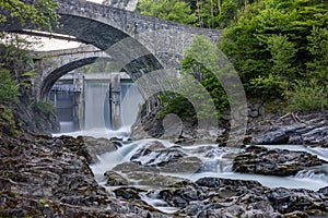 Waterfall behind an old bridge
