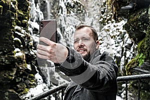 Tourist taking selfie in Bordalsgjelet gorge in Voss, Norway. photo