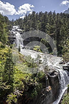 Waterfall cascade in high mountains beside Pont d`Espagne at Marcadau valley, Pyrenees National Park, France photo