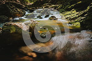 Waterfall or cascade with mountain river along hiking trail